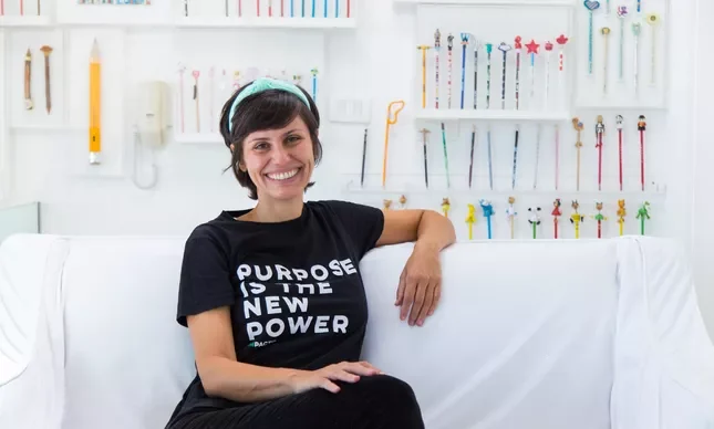Foto da matéria do O Globo sobre a IMPACTO, com a camiseta Purpose is the New Power